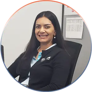 Our Team | Always Responsive, Professional, and Friendly | Our Team | Always Responsive, Professional, and Friendly | Our Team image of Renuka Kulkarni sitting at her desk.