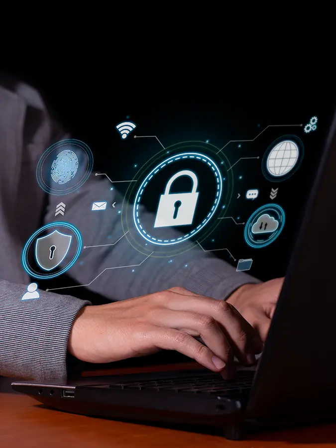 Why Businesses Need Cyber Liability Insurance | The CLARK Report | Why Businesses Need Cyber Liability Insurance | The CLARK Report | DC the Computer Guy - Why All Businesses Need Cyber Liability Insurance image of a person typing on a laptop with a hologram showing a cyber secure environment hovering above.