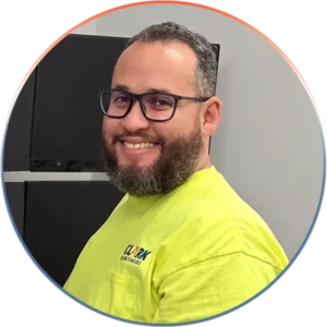 Our Team Provides the Best Professional Responsive and Friendly Service | Our Team Provides the Best Professional Responsive and Friendly Service | Clark Building Technologies Our Team page, image of Ricardo in front of monitor wall.