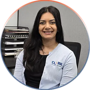Our Team | Always Responsive, Professional, and Friendly | Our Team | Always Responsive, Professional, and Friendly | Our Team image of Renuka Kulkarni sitting at her desk.