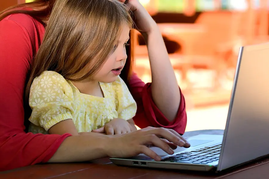 Parental Controls Keep Kids Safe Online | Chuck's Cyber Wall | Parental Controls Keep Kids Safe Online | Chuck's Cyber Wall | Chucks Cyber Wall - Parental Controls image of parent showing child how to stay safe on laptop.