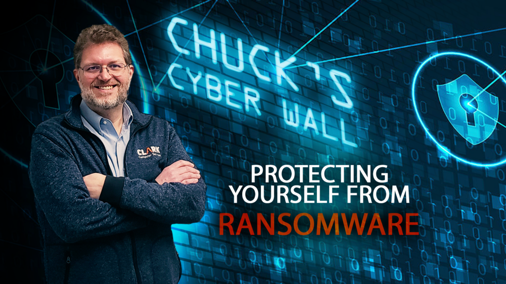 The Clark Report - Your Source of Technology Information | Chuck's Cyber Wall - Protecting Yourself From Ransomware chuck standing in front of logo