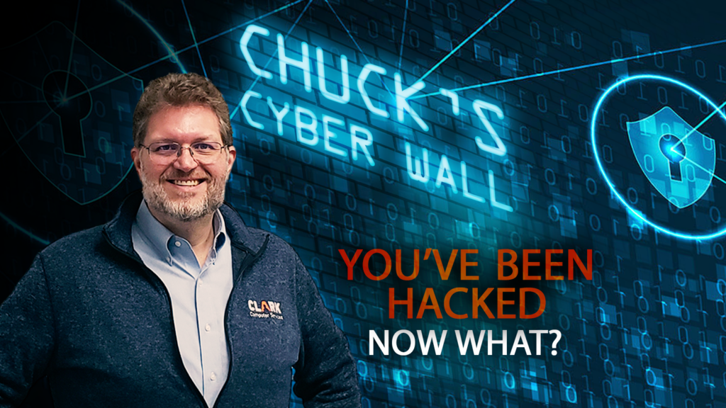 The Clark Report - Your Source of Technology Information | Chuck's Cyber Wall - Youve Been Hacked Logo Image - Chuck standing against logo.