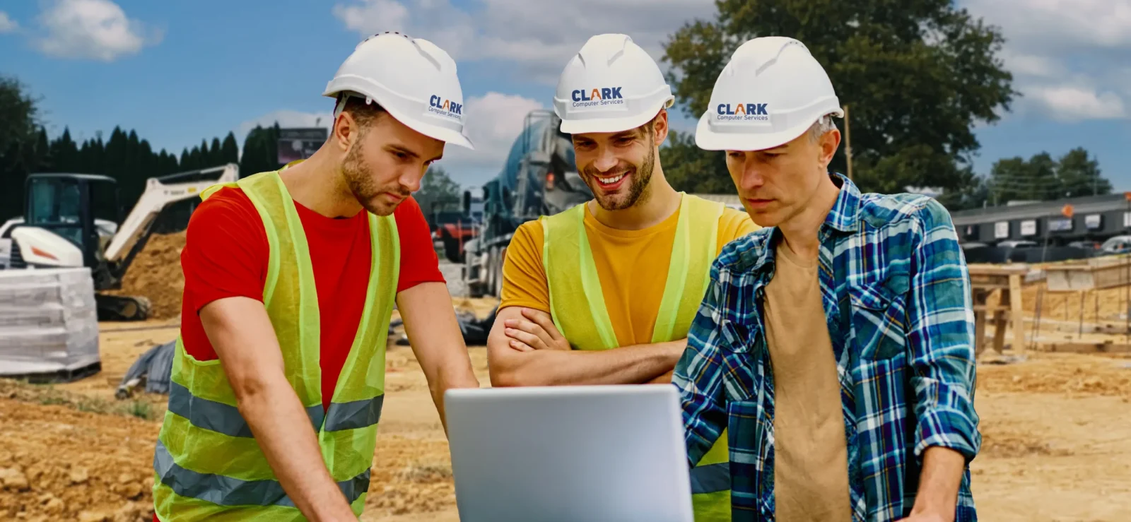 Three Clark technicians on a construction site providing IT support